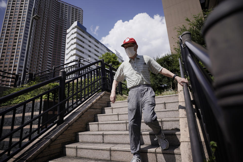 Hidekazu Tamura, 99, takes a walk in Tokyo Friday, Aug. 28, 2020. Amid commemorations for Wednesday's 75th anniversary of the formal Sept. 2 surrender ceremony that ended WWII, Tamura, a former Japanese American living in California, has vivid memories of his time locked up with thousands of other Japanese-Americans in U.S. intern camps. Torn between two warring nationalities, the experience led him to refuse a loyalty pledge to the United States, renounce his American citizenship and return to Japan. (AP Photo/Eugene Hoshiko)