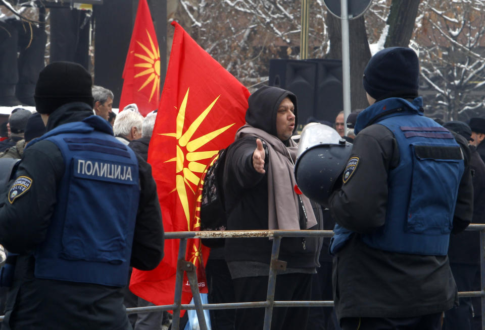 People attend a protest against the change of the country's name outside the parliament building during a session of the Macedonian Parliament in the capital Skopje, Friday, Jan. 11, 2019. Macedonia has fulfilled its part of a deal that will pave its way to NATO membership and normalize relations with neighboring Greece, after lawmakers approved constitutional changes that will rename the country North Macedonia. (AP Photo/Boris Grdanoski)