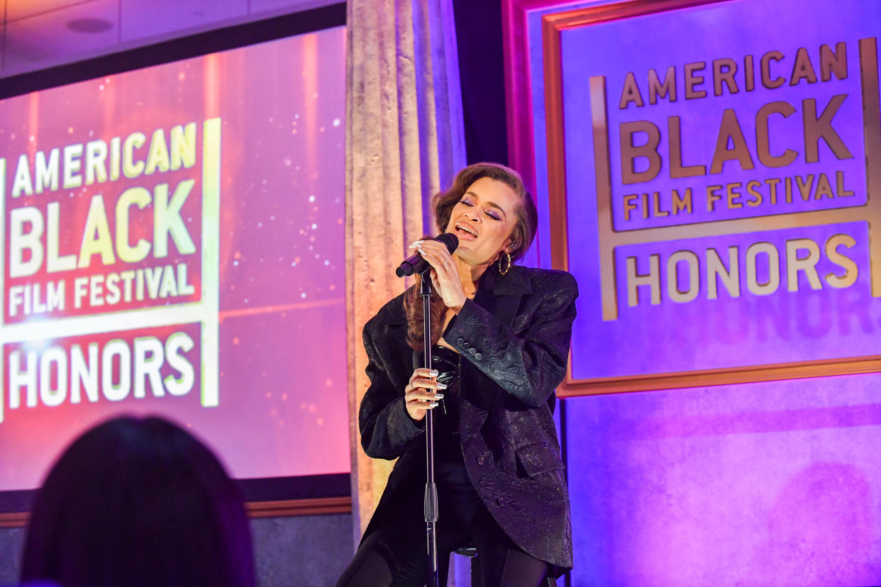 Andra Day delights guests performing a medley of “God Bless the Child” and “Rise Up.”