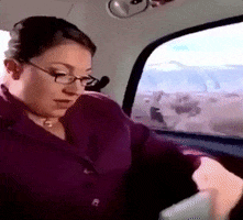 GIF of the Super Nanny in the back of a car saying "You guys are in crisis, I am on my way" 