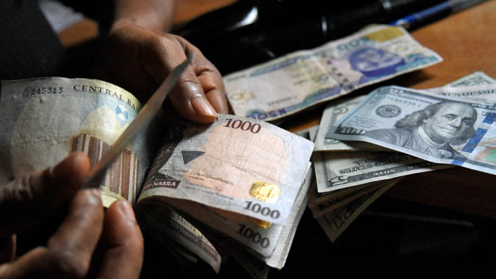 A man exchanges Nigeria&#39;s currency naira for US dollars in Lagos, Nigeria - April 2021