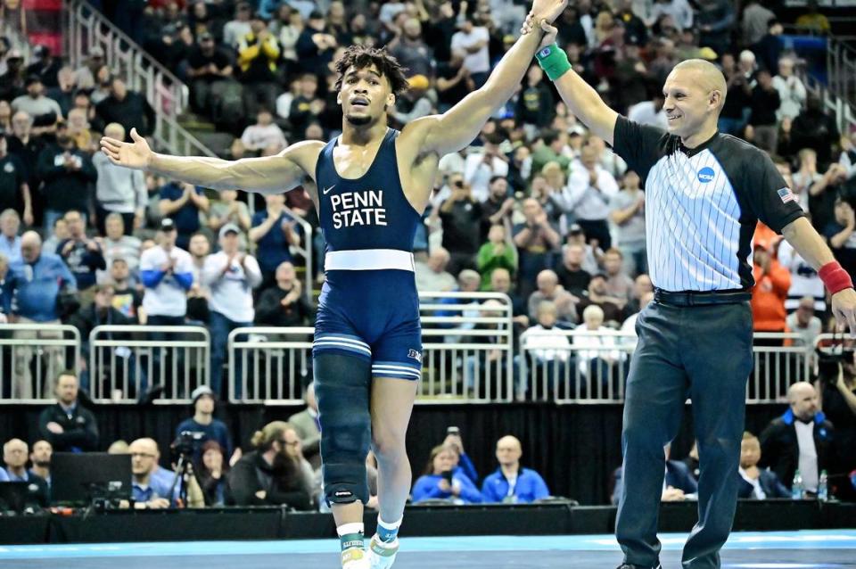 Penn State’s Carter Starocci lifts his arm in victory Saturday night after earning his fourth national title, at 174 pounds, at the T-Mobile Center in Kansas City, Mo. Starocci defeated Ohio State’s Rocco Welsh by a 2-0 decision to become the first Penn State wrestler to ever win four national titles.