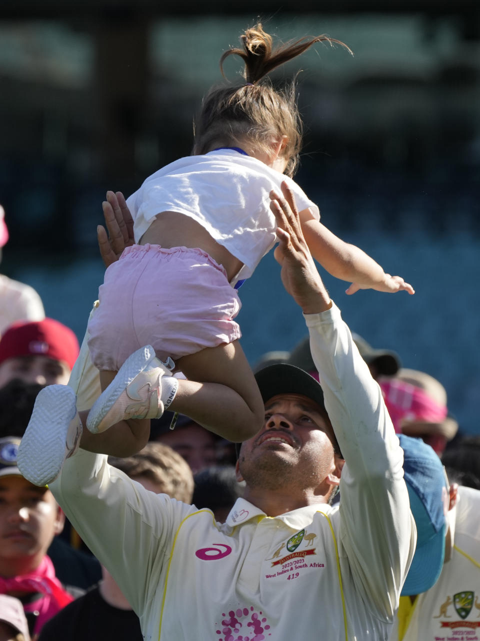 Man of the match Australia's Usman Khawaja plays with his daughter, Aisha, the end of their cricket test match against South Africa at the Sydney Cricket Ground in Sydney, Sunday, Jan. 8, 2023. The match ended in a draw and Australia won the series 2-0. (AP Photo/Rick Rycroft)