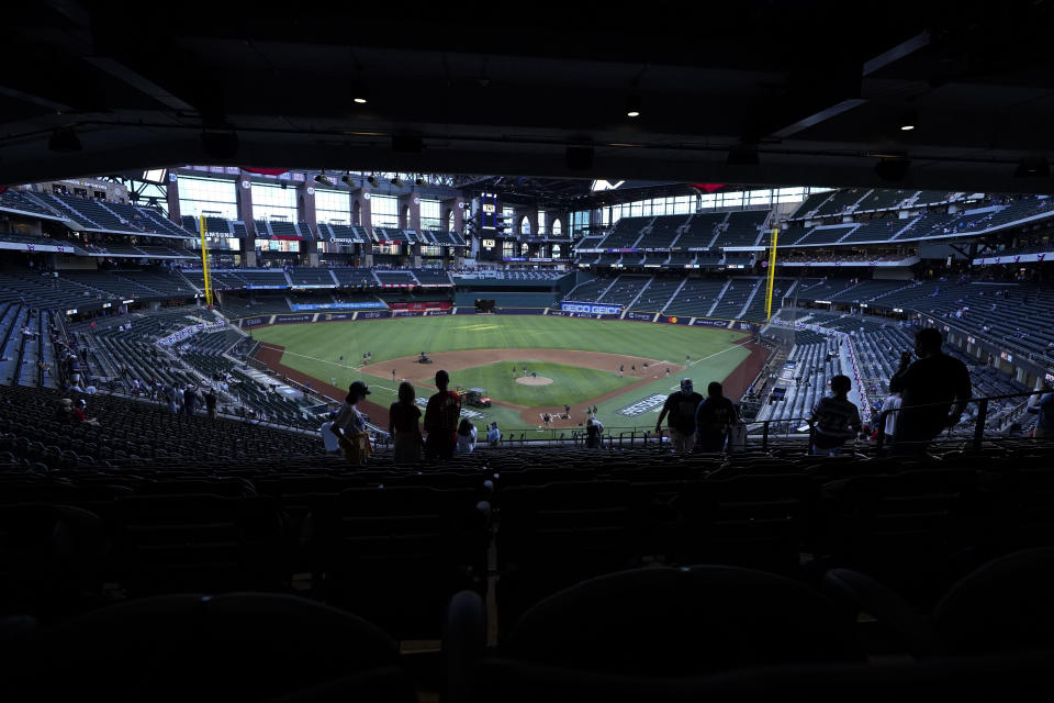 Fans wait for the start of Game 1 of a baseball National League Championship Series between the Los Angeles Dodgers and the Atlanta Braves Monday, Oct. 12, 2020, in Arlington, Texas. (AP Photo/Tony Gutierrez)