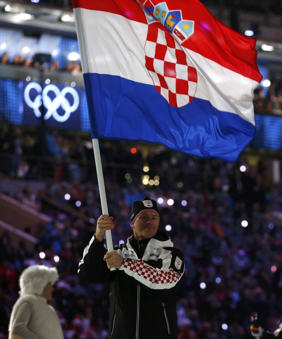 Croatia's flag-bearer Ivica Kostelic leads his country's contingent as they march in during the opening ceremony of the 2014 Sochi Winter Olympics, February 7, 2014. REUTERS/Jim Young (RUSSIA - Tags: OLYMPICS SPORT)