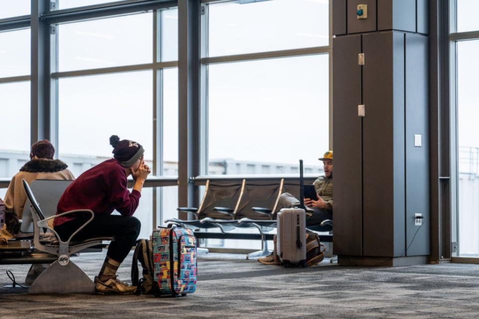 A traveler sits waiting for a flight to depart at Austin Bergstrom International Airport on January 15, 2024.