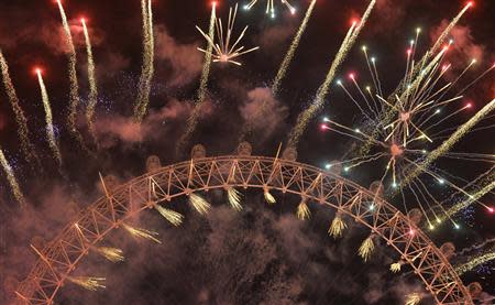 Fireworks explode around the London Eye wheel during New Year celebrations in central London January 1, 2014. REUTERS/Toby Melville