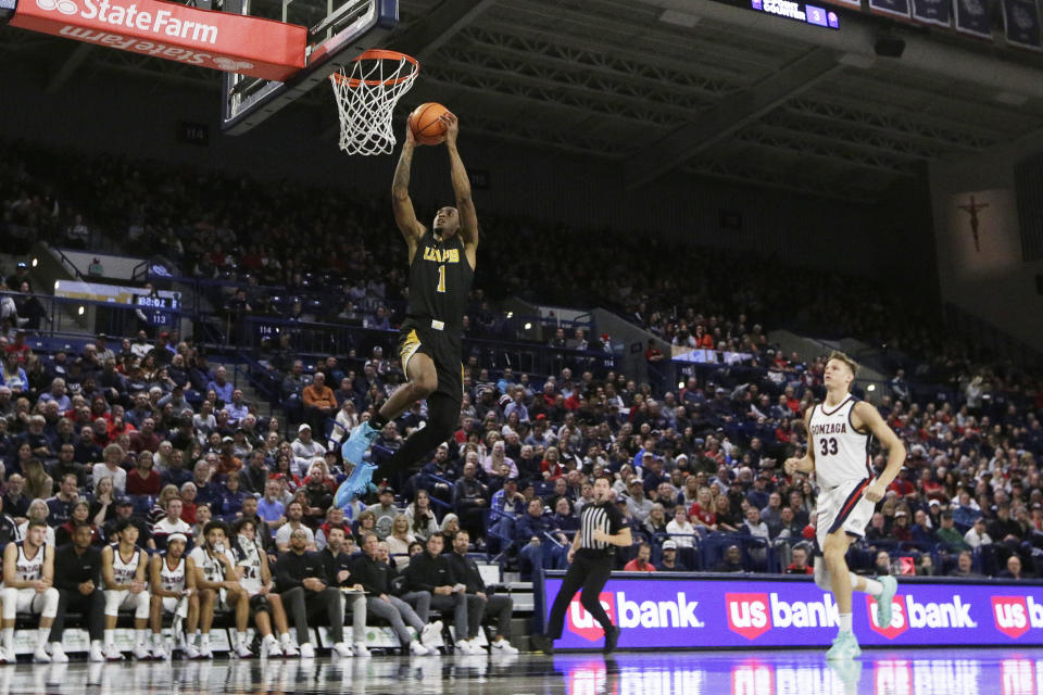 Arkansas-Pine Bluff guard Kylen Milton (1) goes up for a dunk during the first half of an NCAA college basketball game against Gonzaga, Tuesday, Dec. 5, 2023, in Spokane, Wash. (AP Photo/Young Kwak)