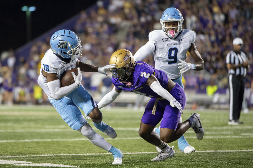 Old Dominion wide receiver Reymello Murphy (18) is tackled by James Madison cornerback Chauncey Logan (2) during the second half of an NCAA college football game Saturday, Oct. 28, 2023, in Harrisonburg, Va. (AP Photo/Mike Caudill)