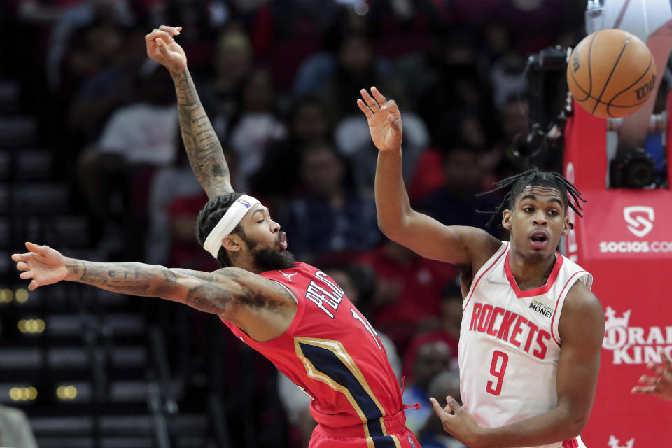 New Orleans Pelicans forward Brandon Ingram, left, loses the ball under pressure from Houston Rockets guard Josh Christopher (9) during the first half of an NBA basketball game, Sunday, Dec. 5, 2021, in Houston. (AP Photo/Michael Wyke)