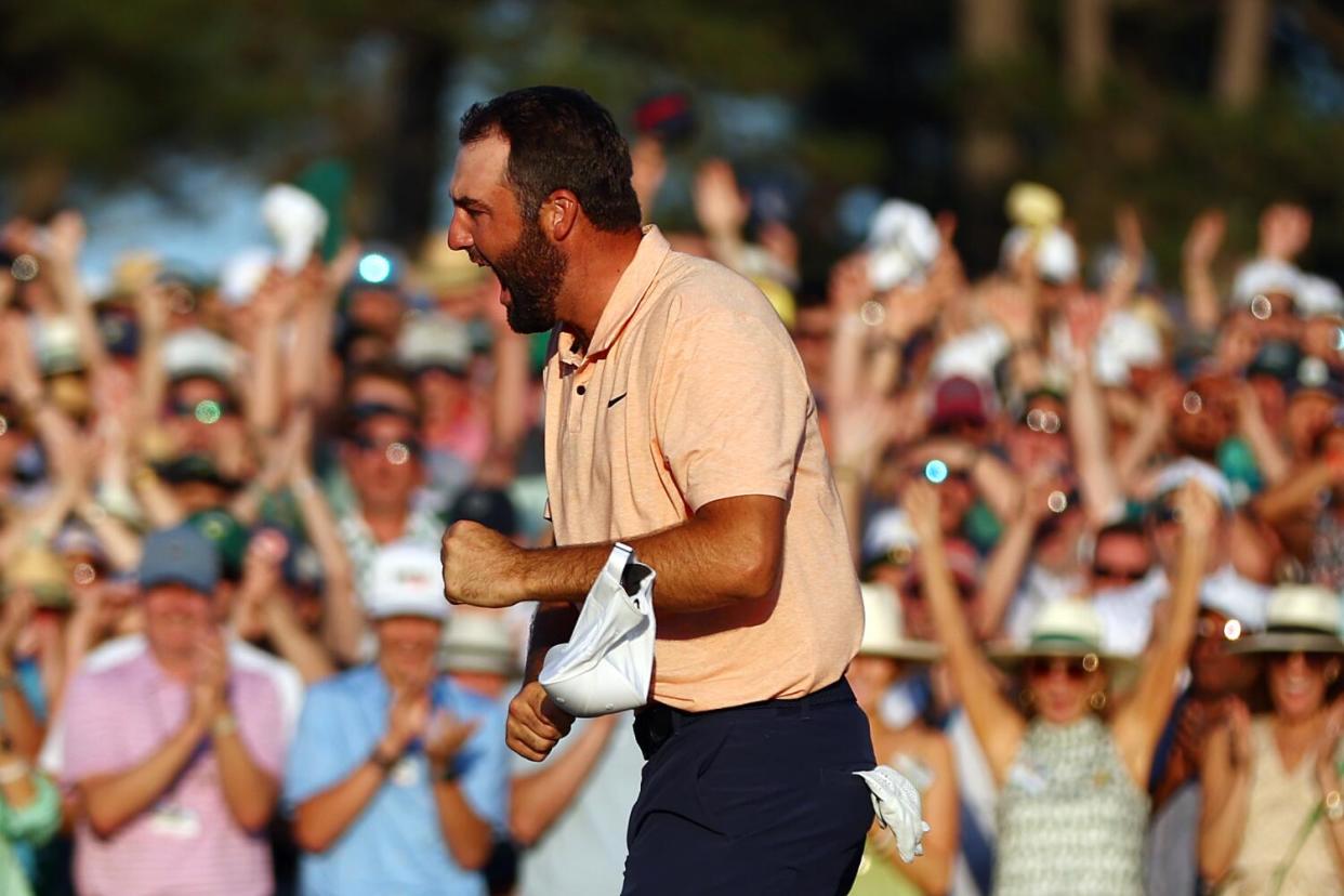 Scottie Scheffler celebrates on the 18th green at Augusta National Golf Club after winning the Masters.