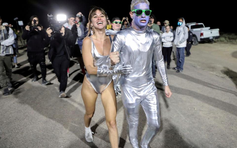 People dressed in costumes chant as they approach a gate to Area 51 in Rachel, Nevada - REUTERS