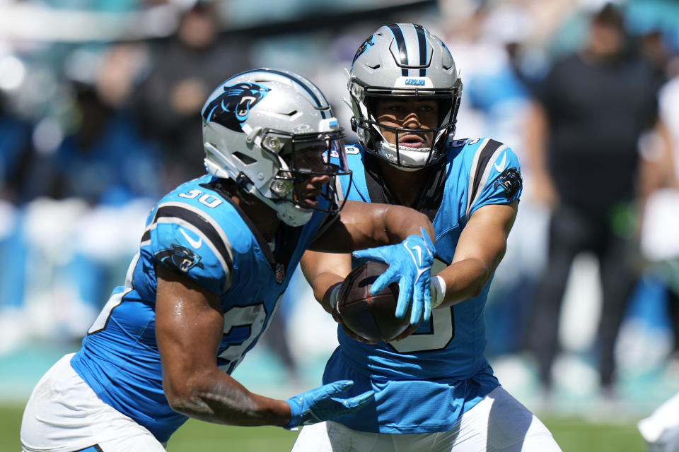 Carolina Panthers quarterback Bryce Young (9) hands the ball to running back Chuba Hubbard (30) during the first half of an NFL football game against the Miami Dolphins, Sunday, Oct. 15, 2023, in Miami Gardens, Fla. (AP Photo/Wilfredo Lee)