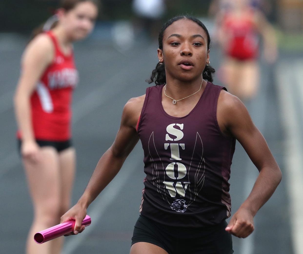 Stow-Munroe Falls' anchor Jayla Atkinson races away after getting the baton in the 4x800 meterrelay during the Suburban League National Conference track at Twinsburg High School on Tuesday, May 7, 2024.