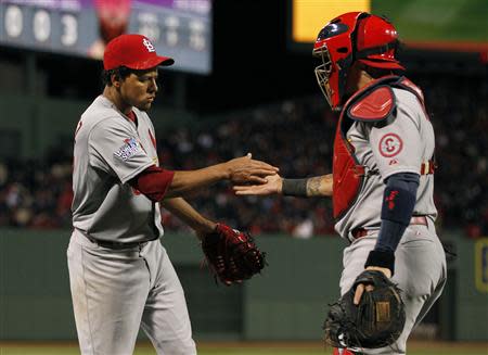 Oct 24, 2013; Boston, MA, USA; St. Louis Cardinals relief pitcher Carlos Martinez (62) celebrates with catcher Yadier Molina (4) after getting out of the eighth inning of game two of the MLB baseball World Series against the Boston Red Sox at Fenway Park. Greg M. Cooper-USA TODAY Sports