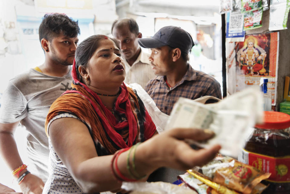 Raj Kumari, 30, shops for rations at a shop in New Delhi on Sept. 5, 2023. (Saumya Khandelwal for NBC News)