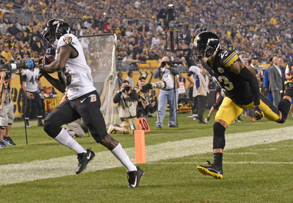 Baltimore Ravens wide receiver John Brown, left, catches a pass from quarterback Joe Flacco for a 33-yard touchdown in front of Pittsburgh Steelers defensive back Joe Haden (23) in the first half of an NFL football game against the Pittsburgh Steelers in Pittsburgh, Sunday, Sept. 30, 2018. (AP Photo/Fred Vuich)