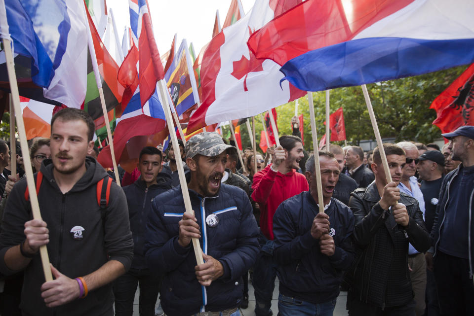 Thousands of supporters of Kosovo's opposition Self-Determination shouting slogans and waving flags of the world countries march through toward Skanderbeg Square on Saturday, Sept. 29, 2018, in Kosovo capital Pristina. Thousands of people in Kosovo are protesting their president's willingness to include a possible territory swap with Serbia in the ongoing negotiations to normalize relations between the two countries. (AP Photo/Visar Kryeziu)