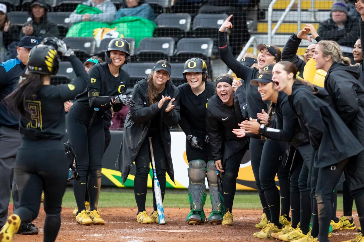 Oregon players celebrate a home run by Oregon outfielder Ariel Carlson as the Oregon Ducks host Washington Saturday, April 6, 2024 at Jane Sanders Stadium in Eugene, Ore.