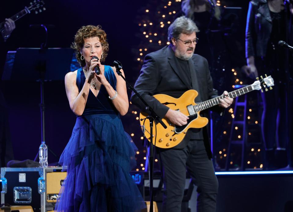 Amy Grant, left, and Vince Gill perform at the Ryman Auditorium on Dec. 13, 2021, in Nashville, Tennessee. Gill said Grant is "doing great" after the Christian singer injured herself in a bicycling accident in July.