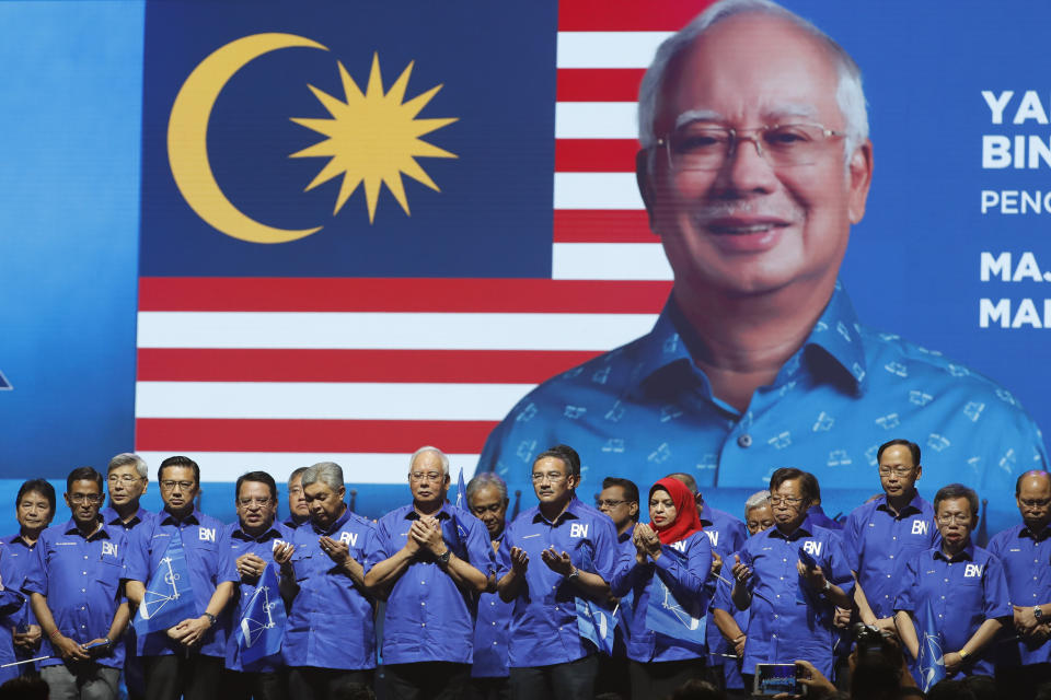 FILE - In this April 7, 2018, file photo, then Malaysia's Prime Minister and President of the ruling party coalition "National Front," Najib Razak, center, prays during launching event for upcoming general elections in Kuala Lumpur, Malaysia. April 7, 2018. Najib Razak on Tuesday, Aug. 23, 2022 was Malaysia’s first former prime minister to go to prison -- a mighty fall for a veteran British-educated politician whose father and uncle were the country’s second and third prime ministers, respectively. The 1MDB financial scandal that brought him down was not just a personal blow but shook the stranglehold his United Malays National Organization party had over Malaysian politics. (AP Photo/Vincent Thian, file)