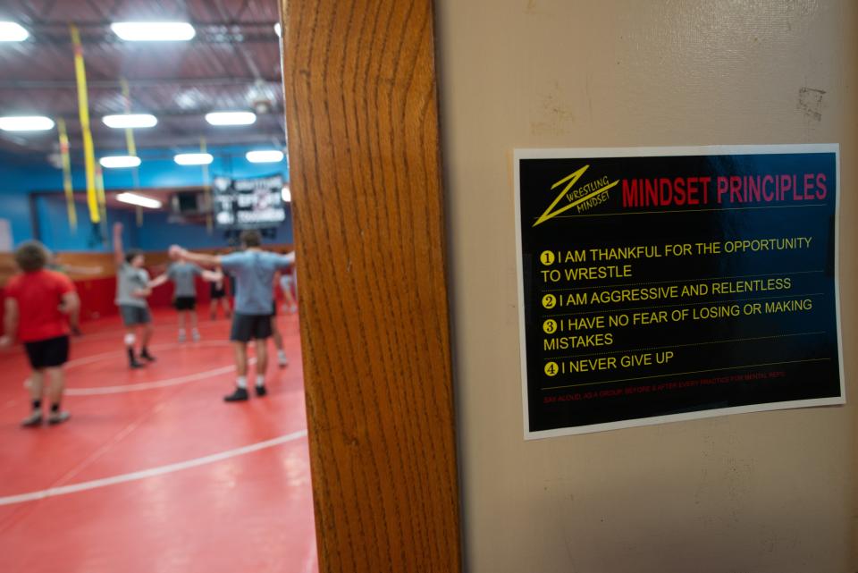 Four mindset principles are laid out as soon as you enter the wrestling practice room at Shawnee Heights.