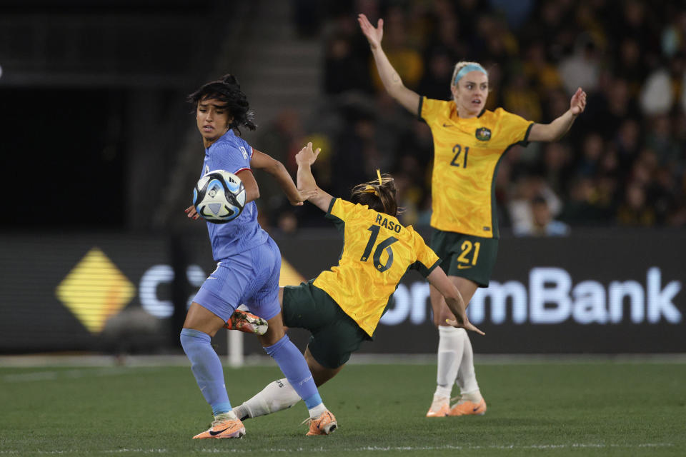 France's Sakina Karchaoui, left, tackles Australia's Hayley Raso during their friendly soccer match in Melbourne, Friday, July 14, 2023, ahead of the Women's World Cup. (AP Photo/Hamish Blair)