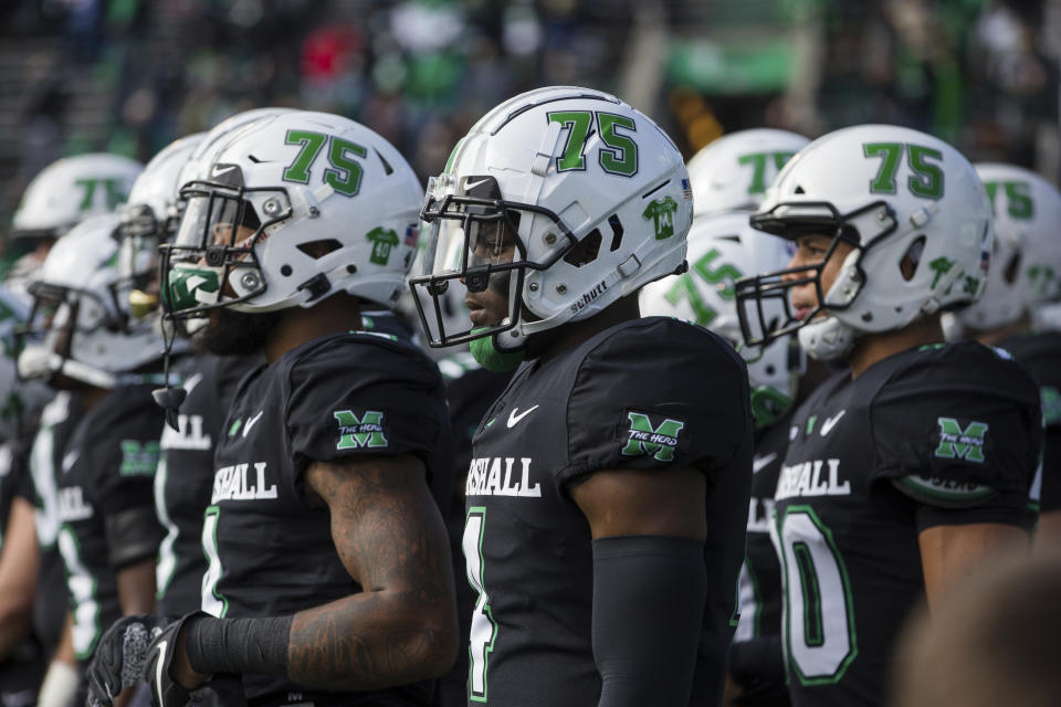 FILE - Marshall players wear a "75" decal on their helmets as they take the field for an NCAA college football game against Middle Tennessee on Nov. 14, 2020, in Huntington, W.Va. The game took place on the 50th anniversary of the 1970 Marshall plane crash that killed all 75 persons aboard. The plane was carrying the Marshall University football team who were returning after a game against East Carolina. A bill has won final legislative approval Wednesday, Feb. 15, 2023, in West Virginia, that would establish an annual day of recognition for the worst sports disaster in U.S. history. (Sholten Singer/The Herald-Dispatch via AP, File)