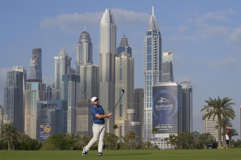 Alex Fitzpatrick of England plays his second shot on 13th hole during the first round of the Hero Dubai Desert Classic golf tournament in Dubai, United Arab Emirates, Thursday, Jan. 18, 2024. (AP Photo/Kamran Jebreili)