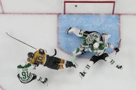 Vegas Golden Knights center Ivan Barbashev (49) scores on Dallas Stars goaltender Jake Oettinger (29) during the first period of Game 5 of the NHL hockey Stanley Cup Western Conference finals Saturday, May 27, 2023, in Las Vegas. (AP Photo/John Locher)