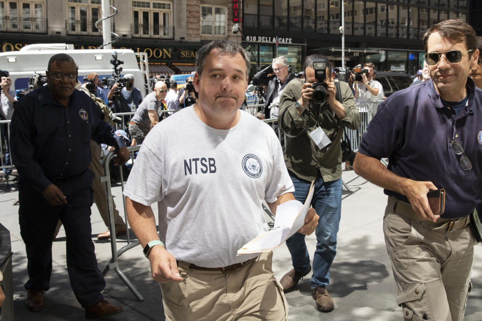 Doug Brazy, an investigator with the National Transportation Safety Board, leaves a news conference, Tuesday, June 11, 2019 in New York. He gave an update on Monday's helicopter crash on the roof of a rain-shrouded Manhattan skyscraper, killing the pilot, Tim McCormack, of Clinton Corners, N.Y. (AP Photo/Mark Lennihan)