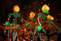 <p>Festive jack-o’-lanterns are carried on poles by handlers in the 44th annual Village Halloween Parade in New York City on Oct. 31, 2017. (Photo: Gordon Donovan/Yahoo News) </p>