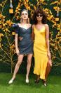 <p>Wearing a short denim dress, and a yellow satin slip dress.</p>