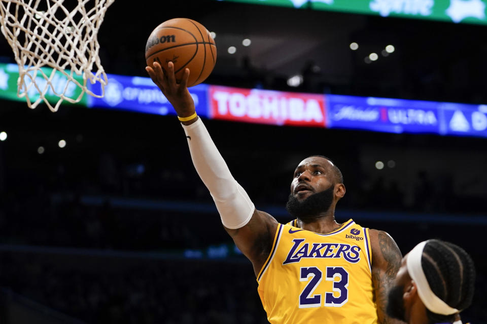 Los Angeles Lakers forward LeBron James lays the ball up during the first half of an NBA basketball game against the Orlando Magic, Monday, Oct. 30, 2023, in Los Angeles. (AP Photo/Ryan Sun)