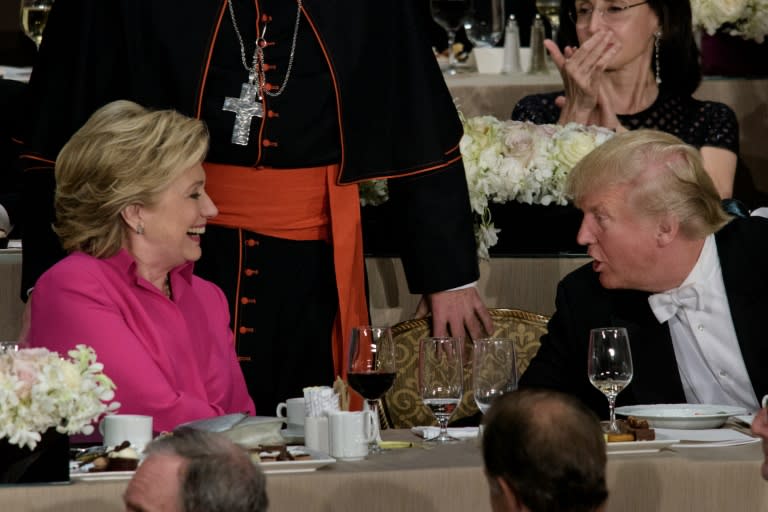 Democratic presidential nominee Hillary Clinton (L) and Republican nominee Donald Trump talk during the Alfred E. Smith Memorial Foundation Dinner at Waldorf Astoria in New York on October 20, 2016