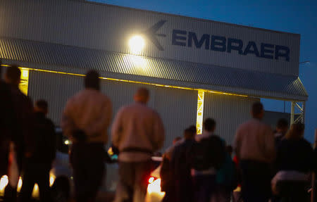 FILE PHOTO: Employees of the Brazilian aviation company Embraer are seen in front of the factory in Sao Jose dos Campos, Brazil, July 24, 2018. REUTERS/Roosevelt Cassio