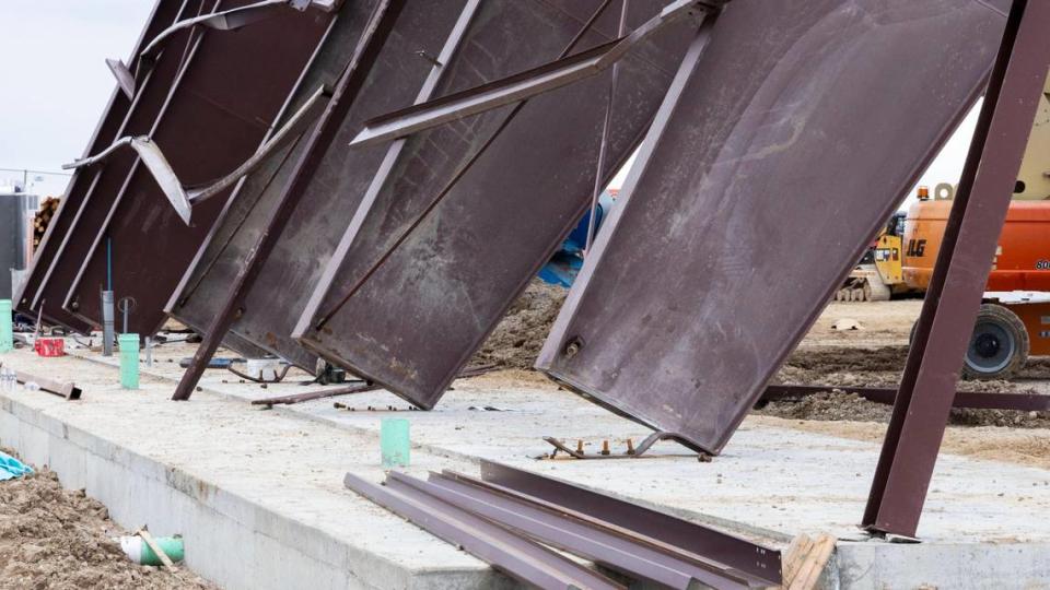 At the construction site where a building collapsed Wednesday near the Boise Airport, wreckage shows twisted girders with a crane in the center. Three workers died at the scene and nine others were injured. The project was an airplane hangar for Jackson Jet Center.