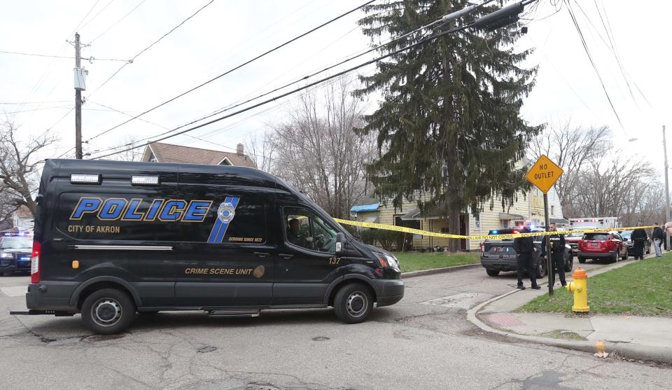 Akron police and members of the Summit County Medical Examiner's Office respond to a boy's shooting death Thursday in Akron's North Hill.