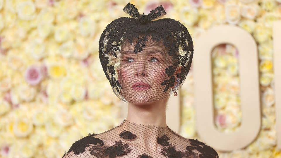 "Saltburn” actress Rosamund Pike’s decision to match her lacy black Fall 2019 Dior couture dress with a veiled fascinator by Philip Treacy came about following a recent skiing accident. "My face was entirely smashed up and I thought, 'I need to do something',” she told the red carpet pre-show presenter Marc Malkin. “Actually, it's healed, but I fell in love with the look.” - Michael Tran/AFP/Getty Images