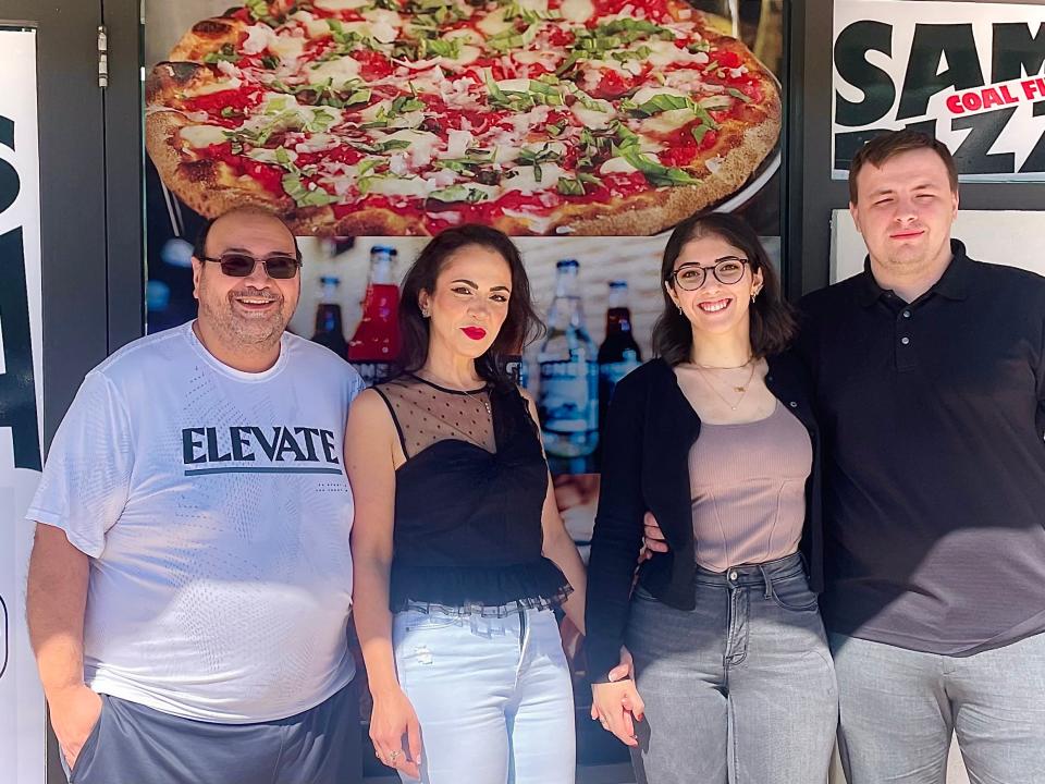 Owner Sam Tadros alongside his wife, Lucy, daughter, Eve, and her fiancé, Jake, at Sam's Coal Fired Pizza restaurant in Daytona Beach.
