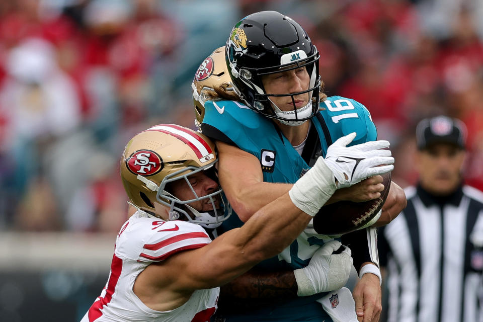 Nick Bosa and Chase Young converge for a strip sack of Trevor Lawrence. (Briggs/Getty Images)