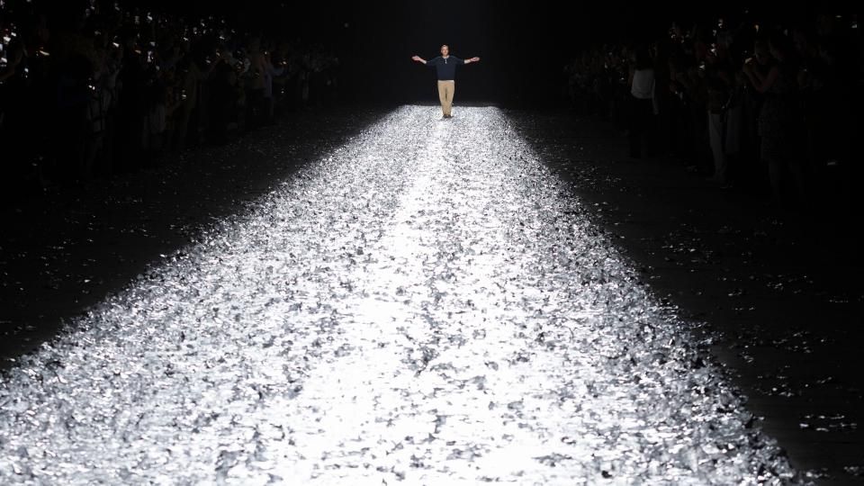 Belgian fashion Designer Dries Van Noten greets the audience at the end of the presentation of his Spring/Summer 2025 Menswear Collection during Paris Fashion Wee