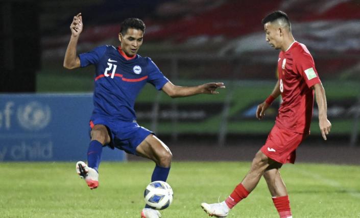 Singapore defender Safuwan Baharudin (left) in action in the Lions' AFC Asian Cup qualifier against Kyrgyzstan in Bishkek. (PHOTO: Football Association of Singapore)