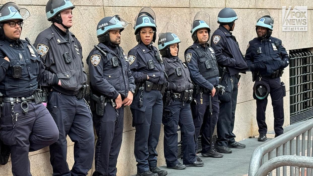 NYPD officers patrol as pro-Palestine protestors demonstrate outside of Columbia University’s campus