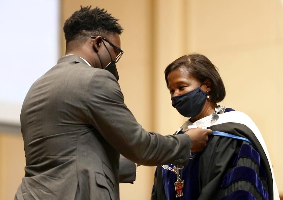 Lawrence University President Laurie A. Carter is presented with the Chain of Office by her son, Carter Walker Robinson, as part of the investiture ceremony during her inauguration Friday, May 13, 2022, in Memorial Chapel in Appleton.