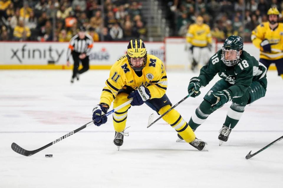 Michigan forward Mackie Samoskevich is defended by Michigan State forward Miroslav Mucha during the first period on Saturday, Feb. 11, 2023, at Little Caesars Arena.