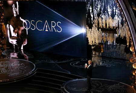 Ellen Degeneres takes a picture of the audience as she hosts the show at the 86th Academy Awards in Hollywood, California March 2, 2014. REUTERS/Lucy Nicholson