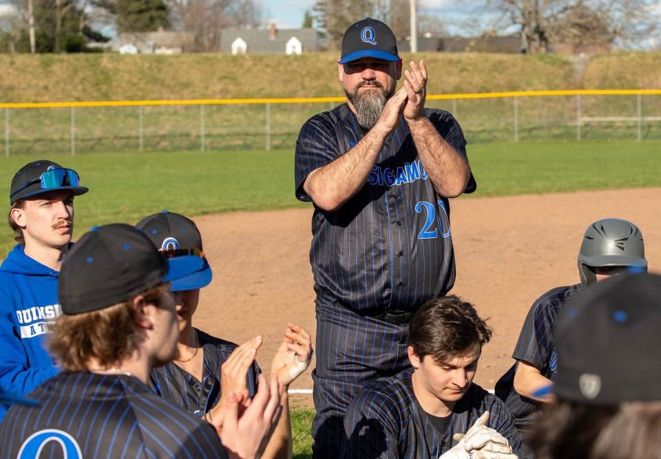 Paul Landry cheers for his team after Quinsigamond beat Holyoke Community College Tuesday.