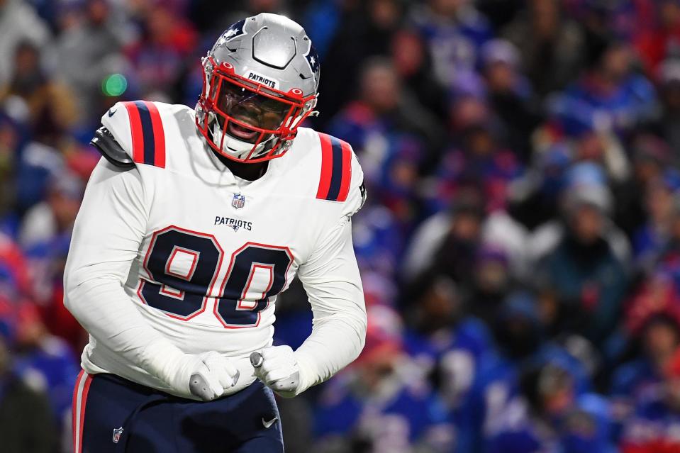 New England Patriots defensive end Christian Barmore (90) reacts to a defensive play against the Buffalo Bills on Dec. 6, 2021, at Highmark Stadium in Orchard Park, New York.