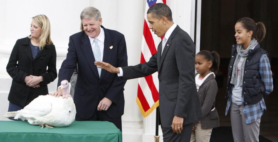 President Barack Obama, with daughters Malia, far right, Sasha, second from the right, pardons the National Thanksgiving Turkey, “Courage,” in a ceremony in the North Portico of the White House, in Washington, Wednesday, Nov. 25, 2009. With Obama is the Chairman of the National Turkey Federation, Walter Pelletier. Woman on left is unidentified. (Photo: Pablo Martinez Monsivais/AP)